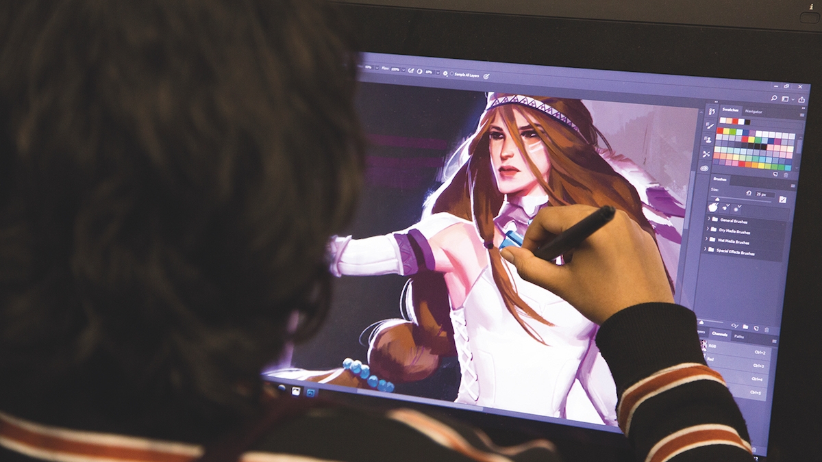 Game Art Student Working Game Art student works on artwork at computer screen