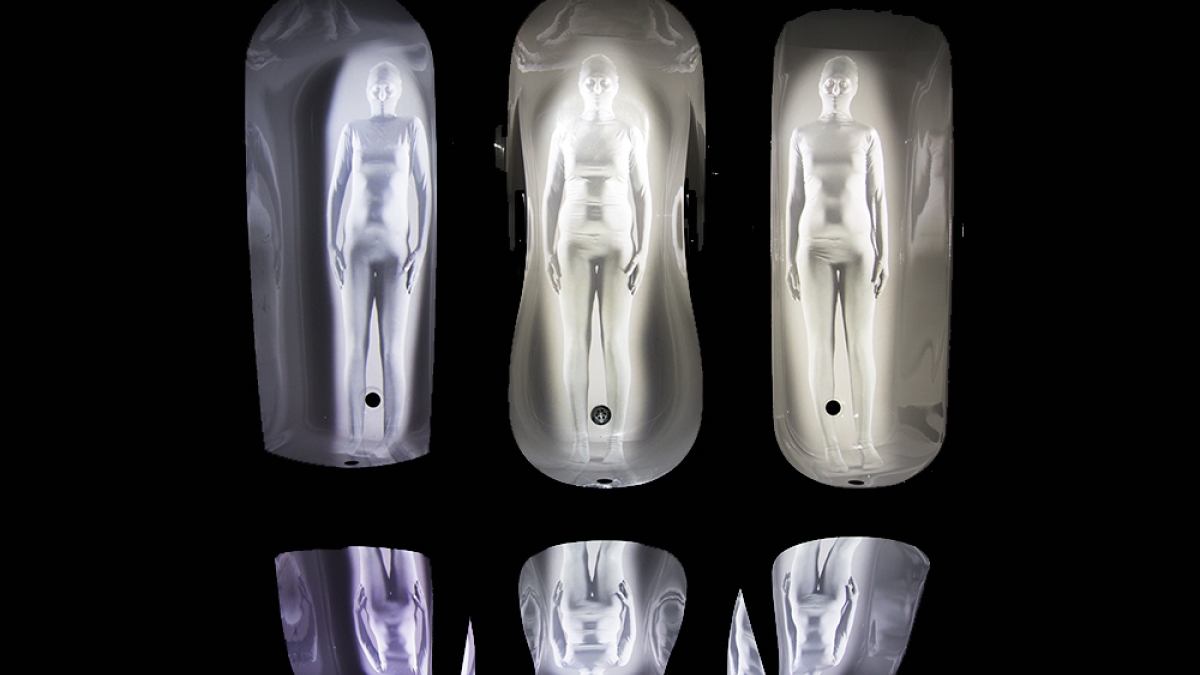 Image of illuminated figures in shiny suits.