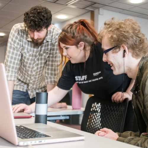 Creative Events Management - Games gauntlet Three students around laptop